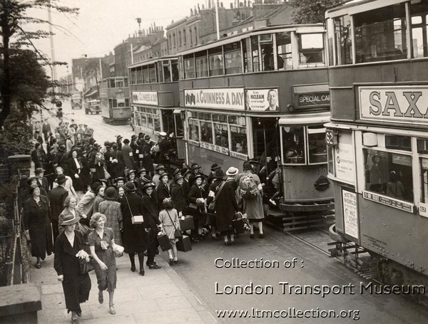 Children from the Charles Edward Brooke (girls) School boarding trams in Camberwell New Road. The children are to be taken to Waterloo station for evacuation, 1939. (1998/36461)